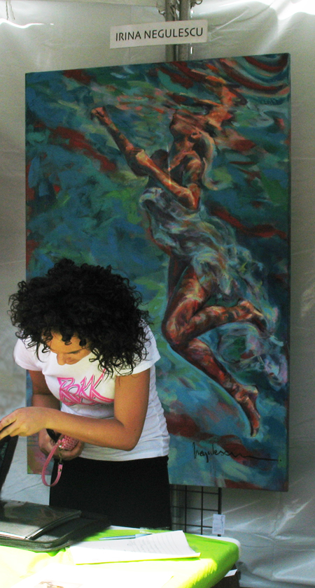 ArtWalk attendee studies Negulescu's portfolio