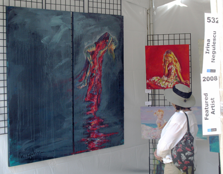 ArtWalk attendee studies Negulescu's most recent work